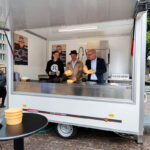 Sandra Neu (greenbox), Manuel Jänig (Musikszene Bremen e.V.), and Martin Schulze (Environmental Enterprises and Alliance for Reusables) inside the Dishwashing Mobile.